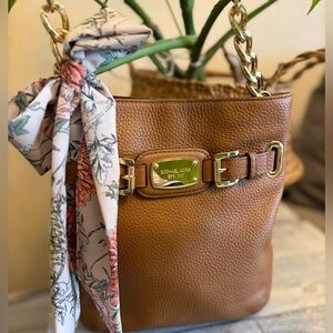 Michael Kors Tan Pebbled Leather crossbody with Gold Chain in the strap.